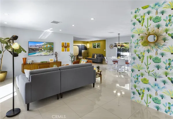 a living room with furniture and painting on the wall