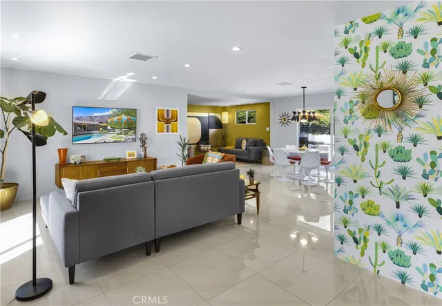 a living room with furniture and painting on the wall