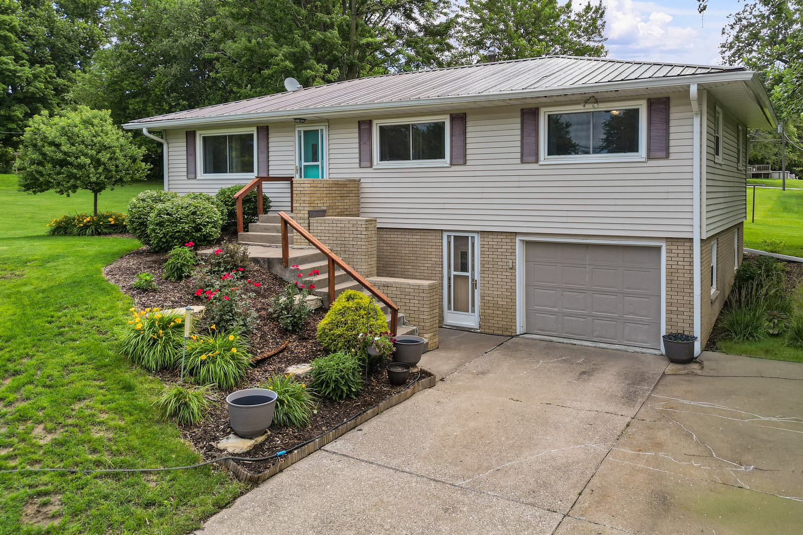 506 Bush Street Reynolds, IL 61279 - Photo 2 of 37 a front view of a house with garden