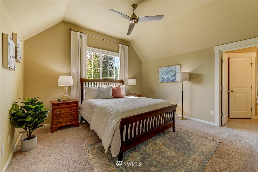 21802 38th Drive Southeast Bothell, WA 98021 - Photo 12 of 26 a bedroom with a bed and a chandelier