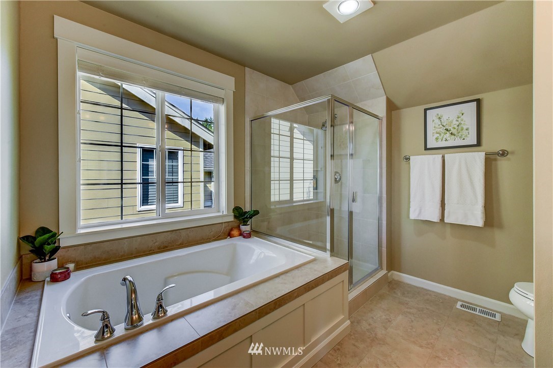 21802 38th Drive Southeast Bothell, WA 98021 - Photo 16 of 26 a bath tub sitting in a bathroom next to a window