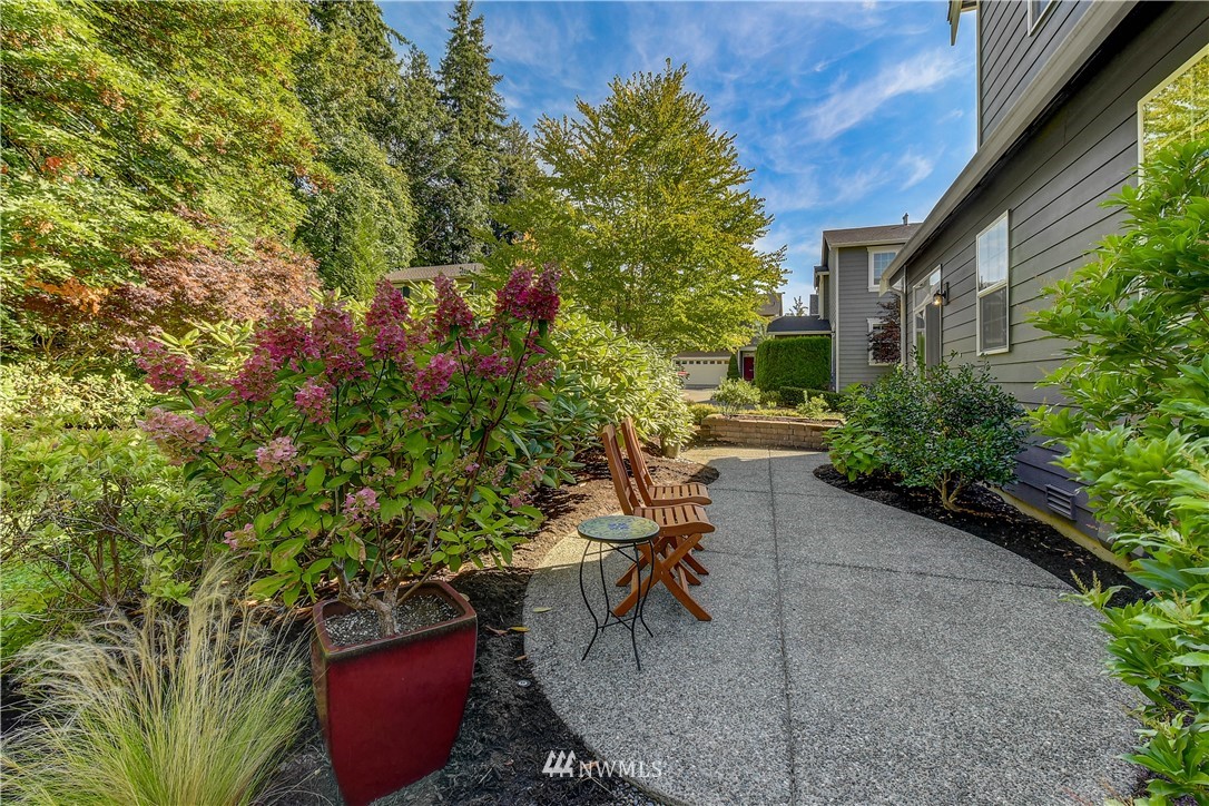 21802 38th Drive Southeast Bothell, WA 98021 - Photo 23 of 26 a view of a patio with table and chairs and potted plants