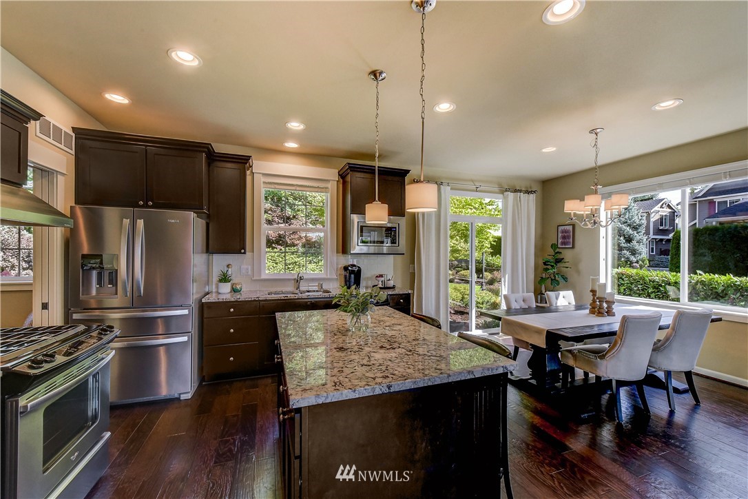 21802 38th Drive Southeast Bothell, WA 98021 - Photo 5 of 26 a kitchen with kitchen island a large counter top space appliances and a center island