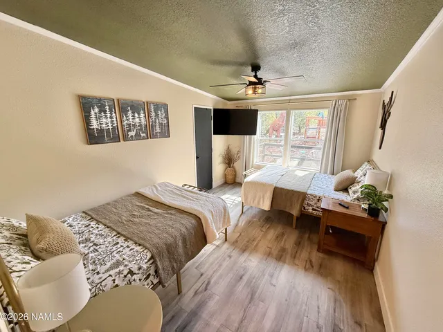 a bedroom with a large bed couch and a window