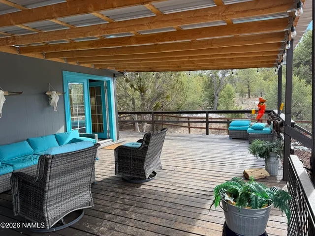 a outdoor space with the couches and dining table with wooden floor