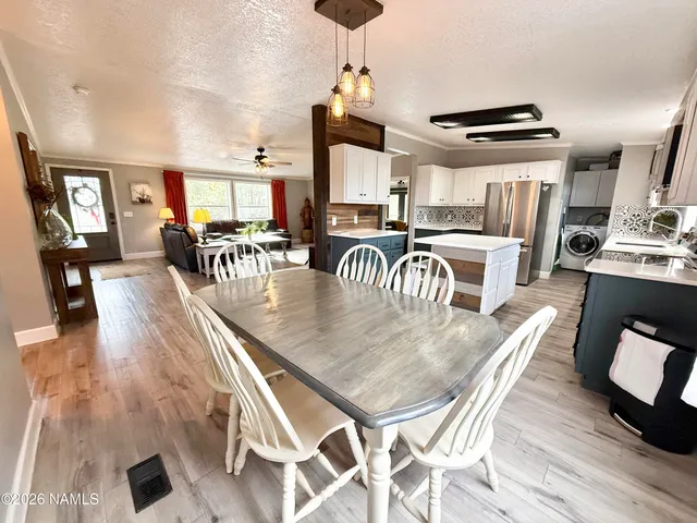 a dining room with furniture and wooden floor