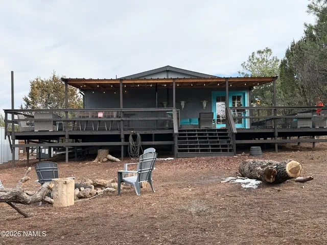 a view of house with backyard and seating area