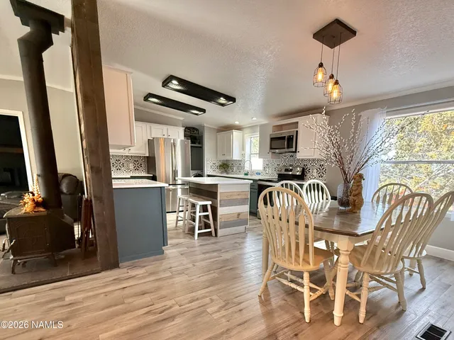 a dining room with furniture a window and wooden floor