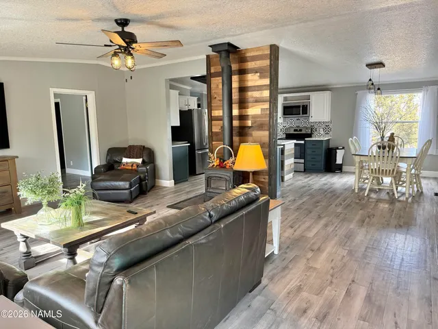 a kitchen with a sink appliances and wooden floor