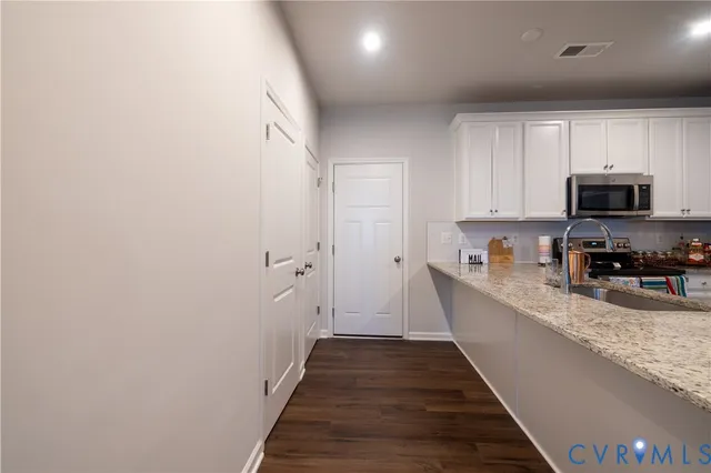 a view of a kitchen with a sink and a refrigerator