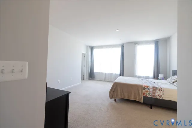 a bedroom with a bed and a couch