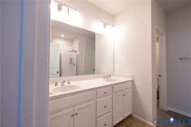 a bathroom with a glass shower door
