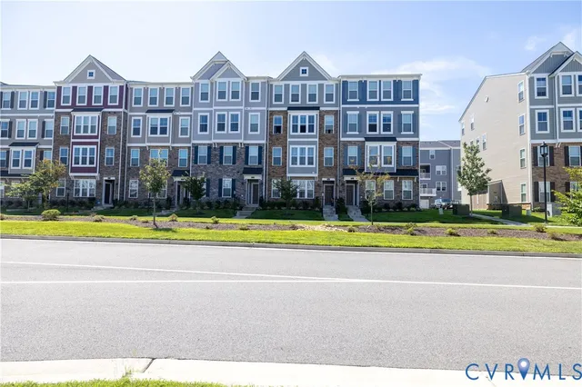 a view of large building with a big yard and palm trees