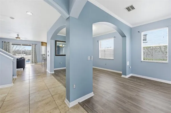 wooden floor in an empty room with a chandelier