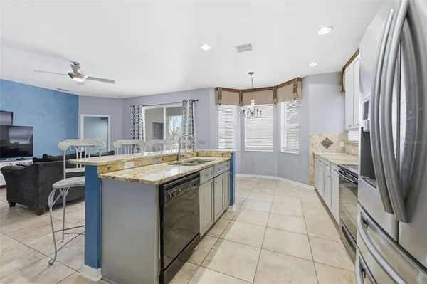 a living room with furniture and kitchen view