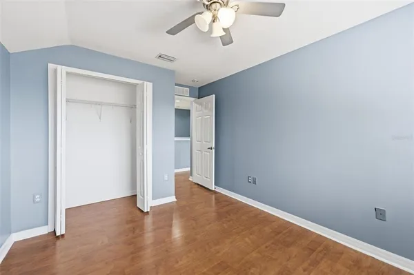 a living room with furniture and a ceiling fan