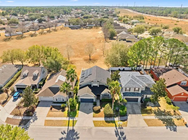 an aerial view of a house with swimming pool and patio