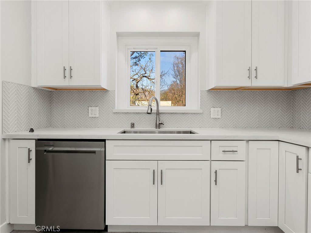 2739 Millicent Way Pasadena, CA 91107 - Photo 11 of 49 a kitchen with white cabinets and a window