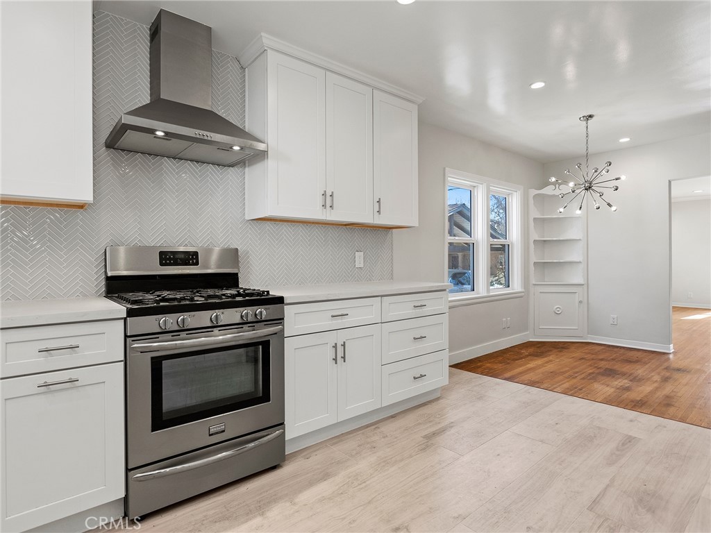 2739 Millicent Way Pasadena, CA 91107 - Photo 13 of 49 a kitchen with granite countertop stainless steel appliances a stove cabinets and a counter top space