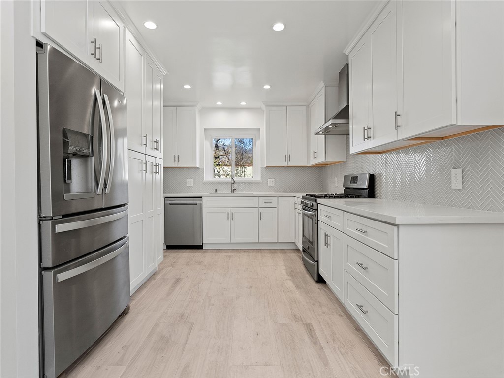 2739 Millicent Way Pasadena, CA 91107 - Photo 8 of 49 a kitchen with white cabinets stainless steel appliances and a sink