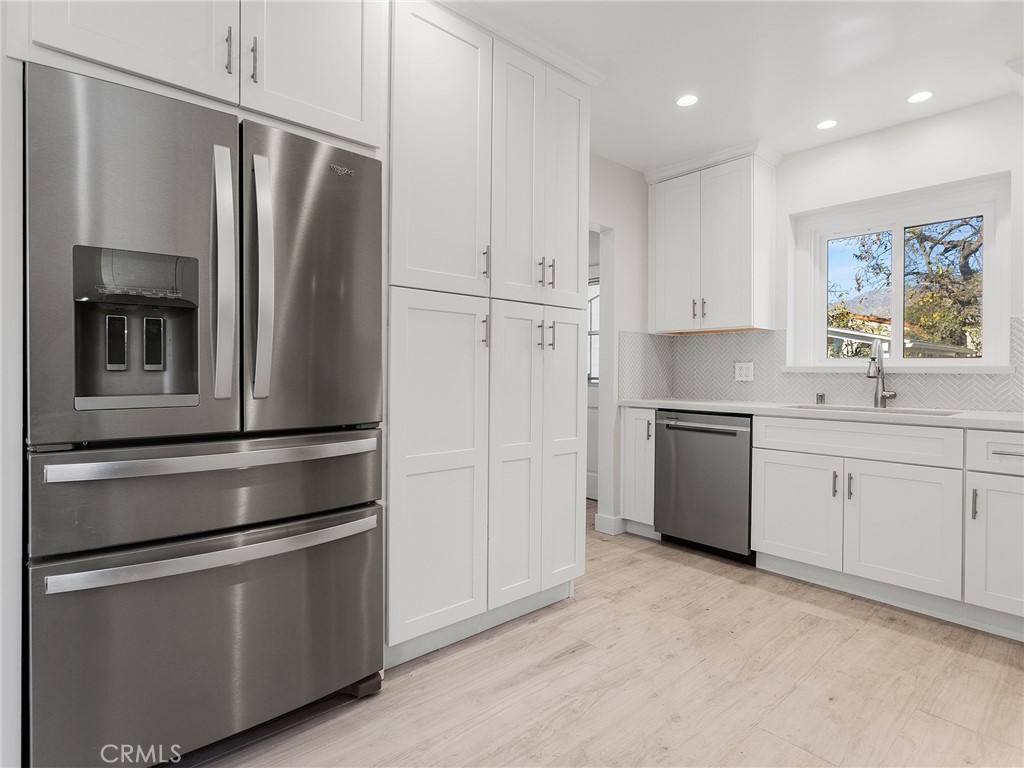 2739 Millicent Way Pasadena, CA 91107 - Photo 10 of 49 a kitchen with stainless steel appliances white cabinets and a refrigerator