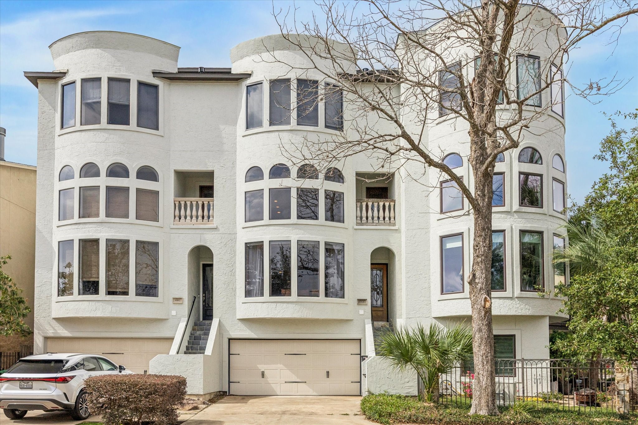 a front view of a building with a garden