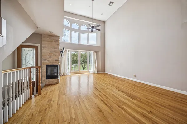 a view of a room with wooden floor and fireplace