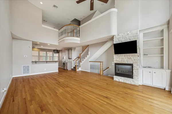 a view of an empty room with a fireplace and a window