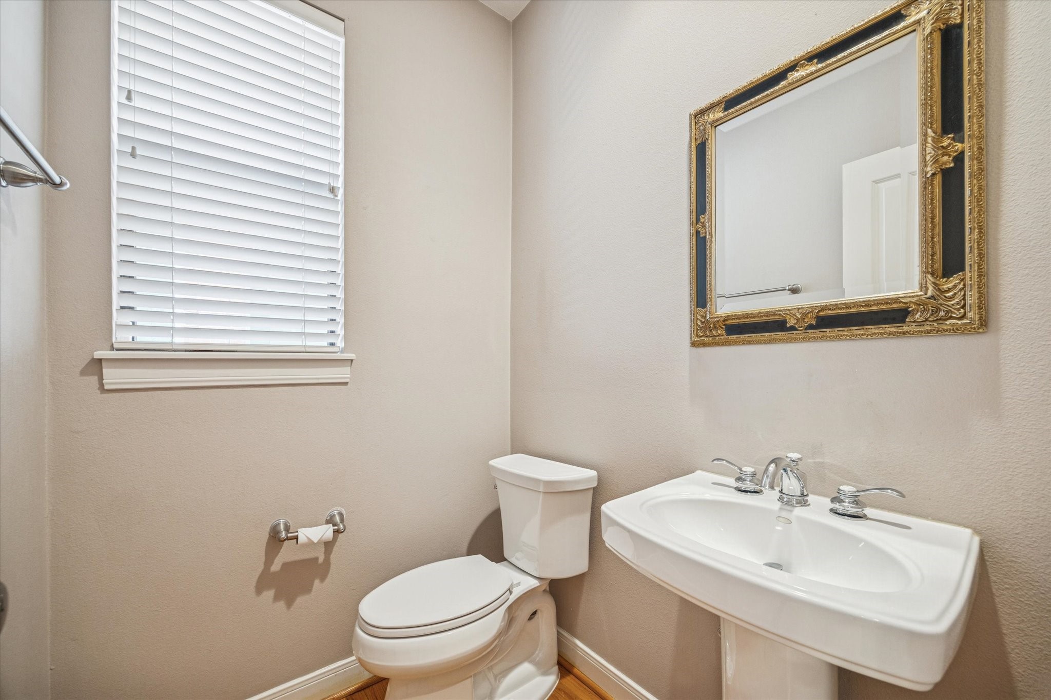 6406 Coppage Street Houston, TX 77007 - Photo 6 of 18 a bathroom with a toilet a sink and a mirror