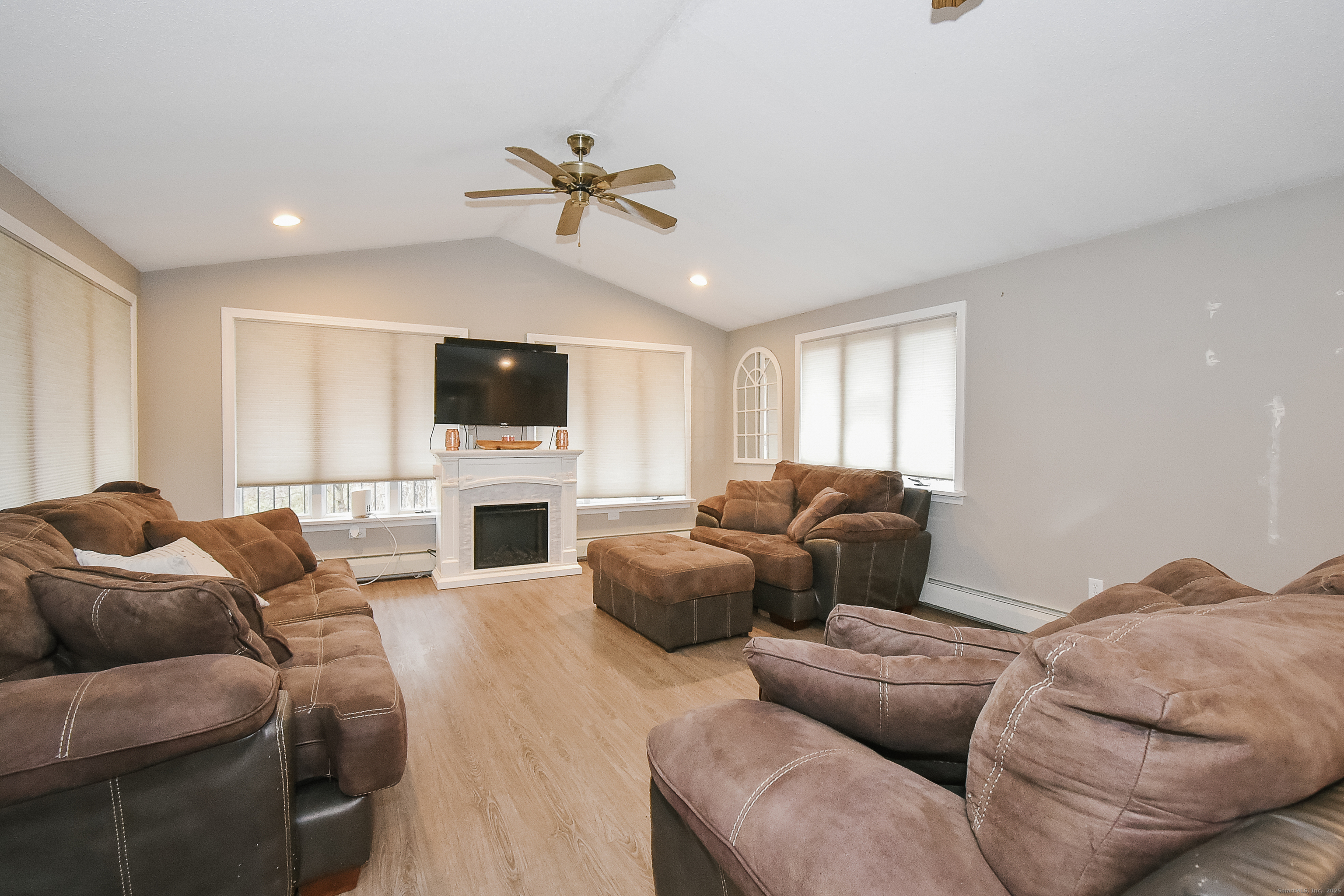 291 Hog Hill Road East Hampton, CT 06424 - Photo 12 of 24 a living room with furniture a fireplace and a flat screen tv