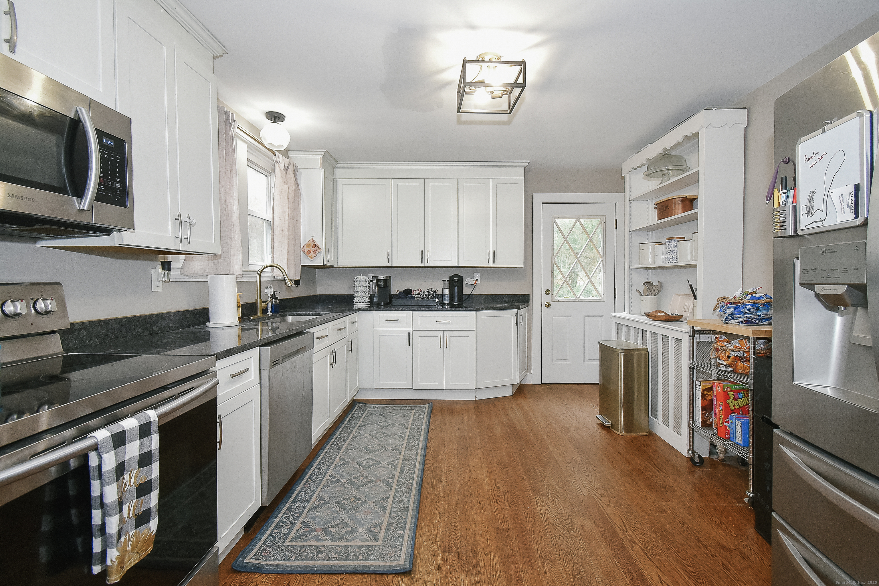 291 Hog Hill Road East Hampton, CT 06424 - Photo 7 of 24 a large kitchen with stainless steel appliances granite countertop a stove a sink dishwasher and a microwave oven with large wooden cabinets