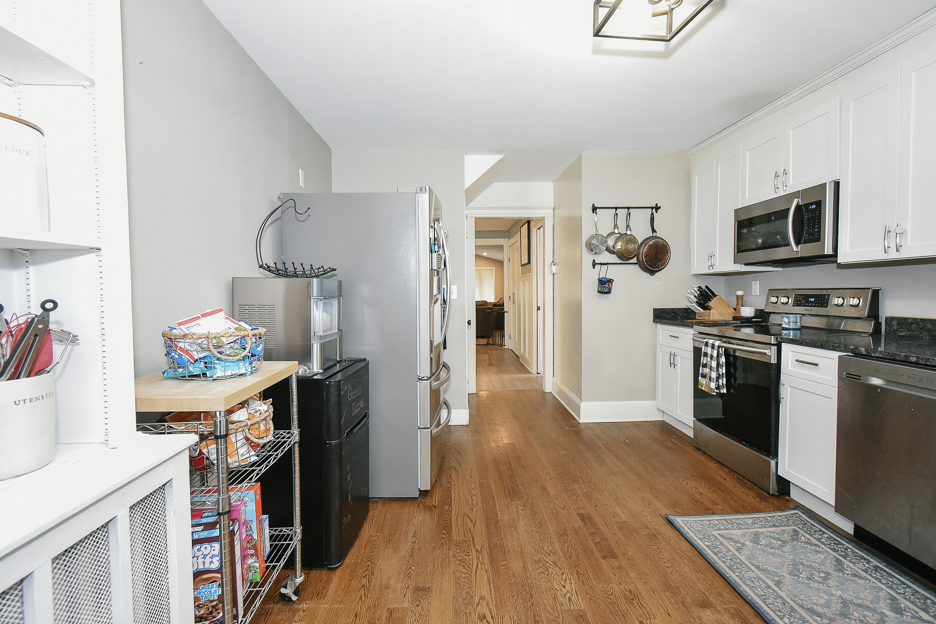 291 Hog Hill Road East Hampton, CT 06424 - Photo 9 of 24 a kitchen with stainless steel appliances granite countertop a refrigerator stove and wooden floor