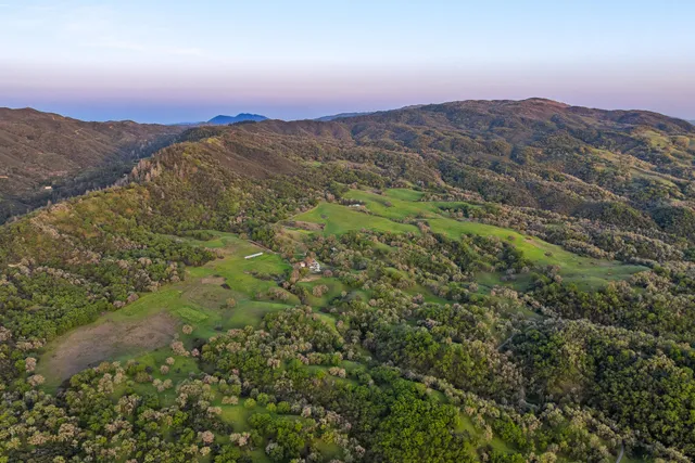 a view of an ocean from a mountain