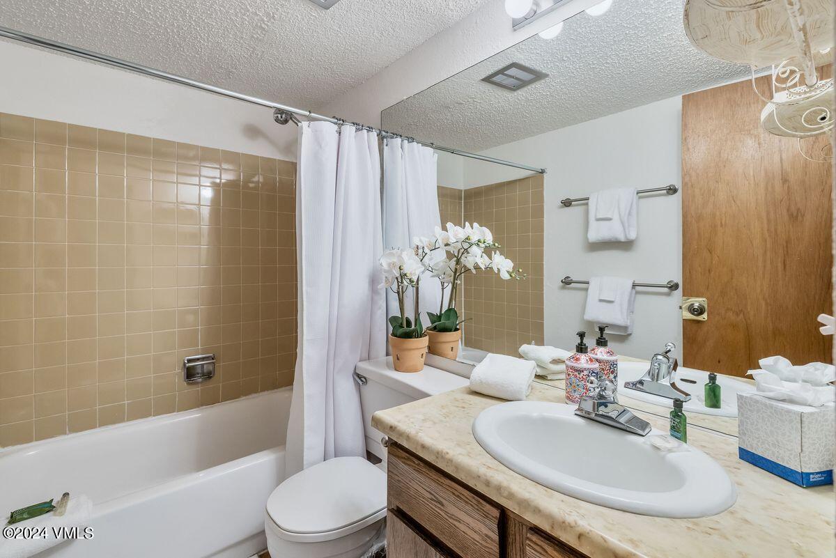 442 South Frontage Road East, Unit A205 Vail, CO 81657 - Photo 12 of 24 a bathroom with a sink a toilet and shower