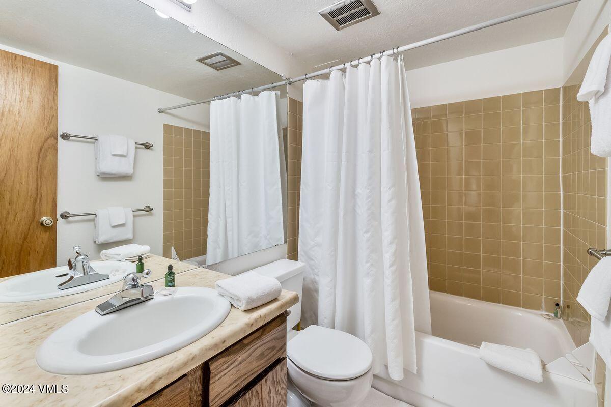 442 South Frontage Road East, Unit A205 Vail, CO 81657 - Photo 13 of 24 a bathroom with a sink toilet and shower