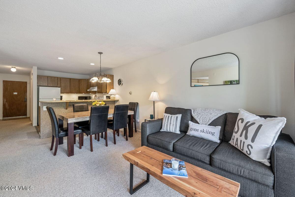442 South Frontage Road East, Unit A205 Vail, CO 81657 - Photo 3 of 24 a living room with furniture and a dining table