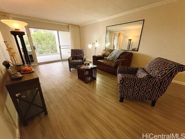 469 Ena Road, Unit 504 Honolulu, HI 96815 - Photo 1 of 1 a living room with furniture and a flat screen tv