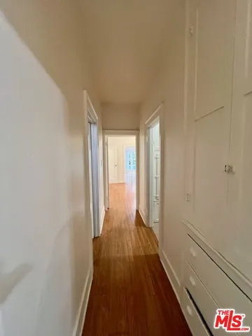 a view of hallway with wooden floor