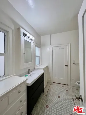a spacious bathroom with a sink and a mirror