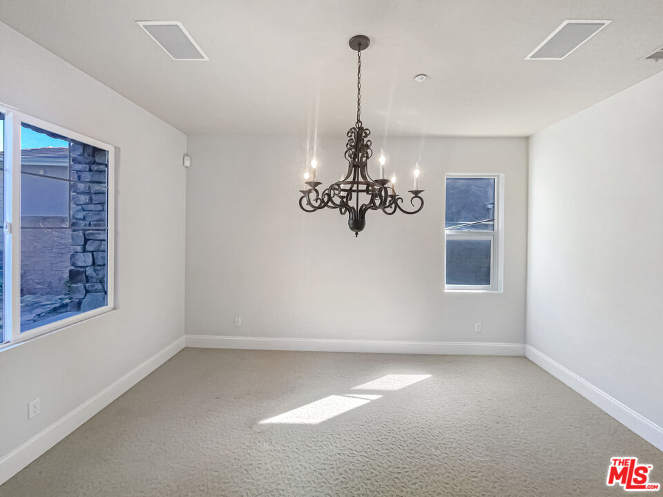 3946 Whistle Train Road Brea, CA 92823 - Photo 12 of 34 a view of a room with a window and a chandelier