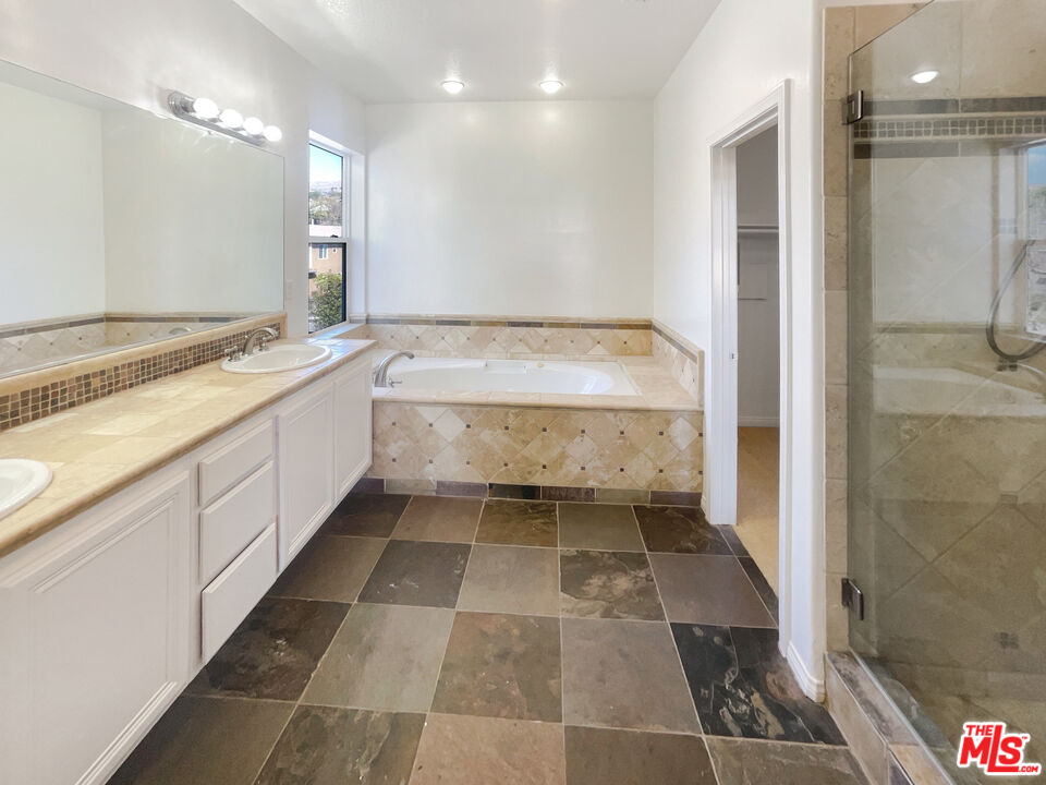 3946 Whistle Train Road Brea, CA 92823 - Photo 26 of 34 a bathroom with a tub sink and mirror