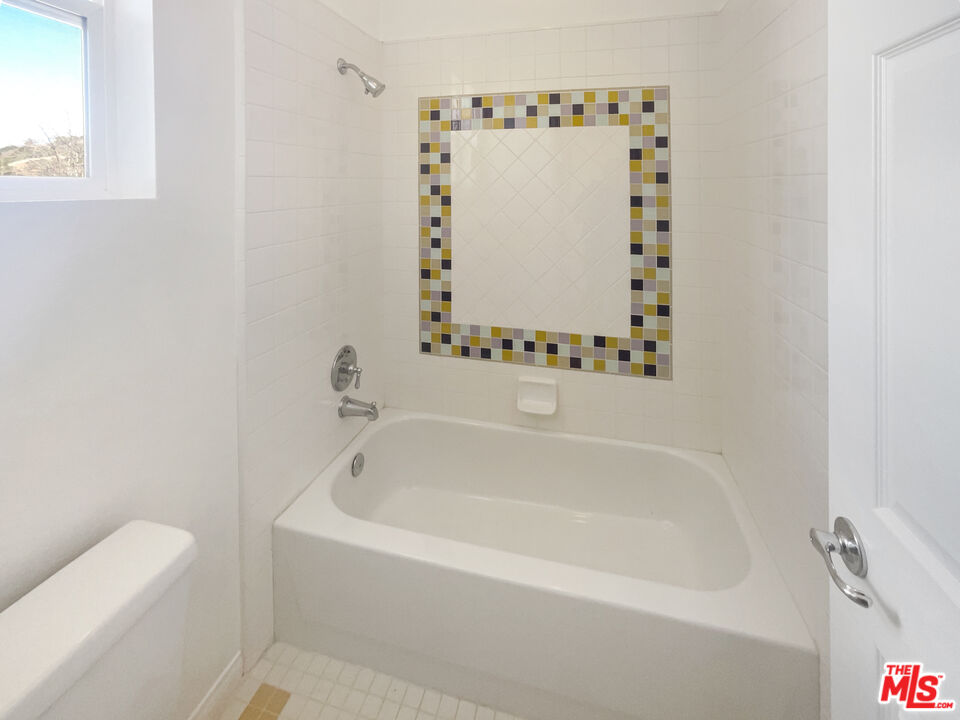 3946 Whistle Train Road Brea, CA 92823 - Photo 31 of 34 a white bath tub sitting next to a white sink and vanity