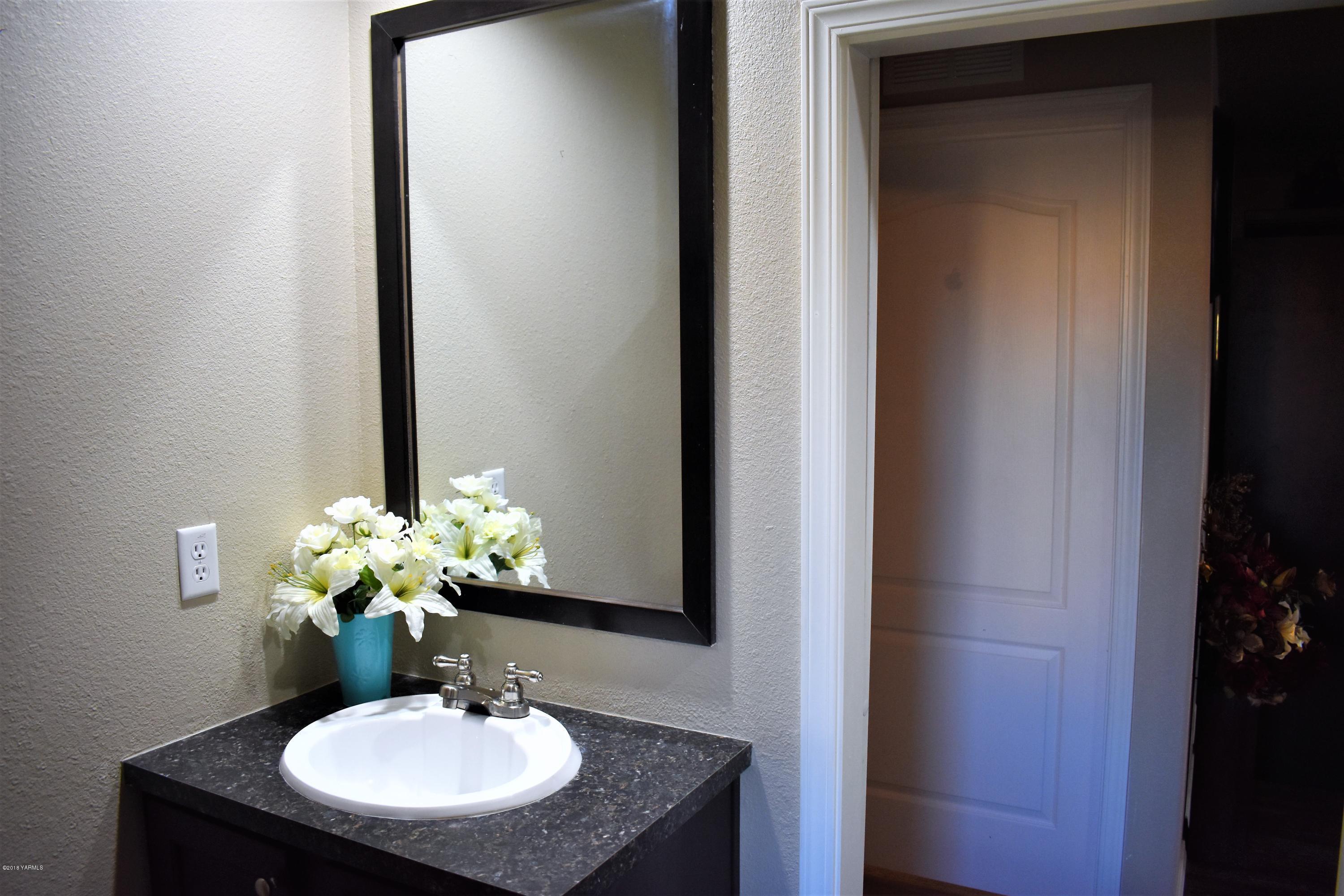 303 Hanks Road Grandview, WA 98930 - Photo 12 of 15 a bathroom with a sink and a mirror