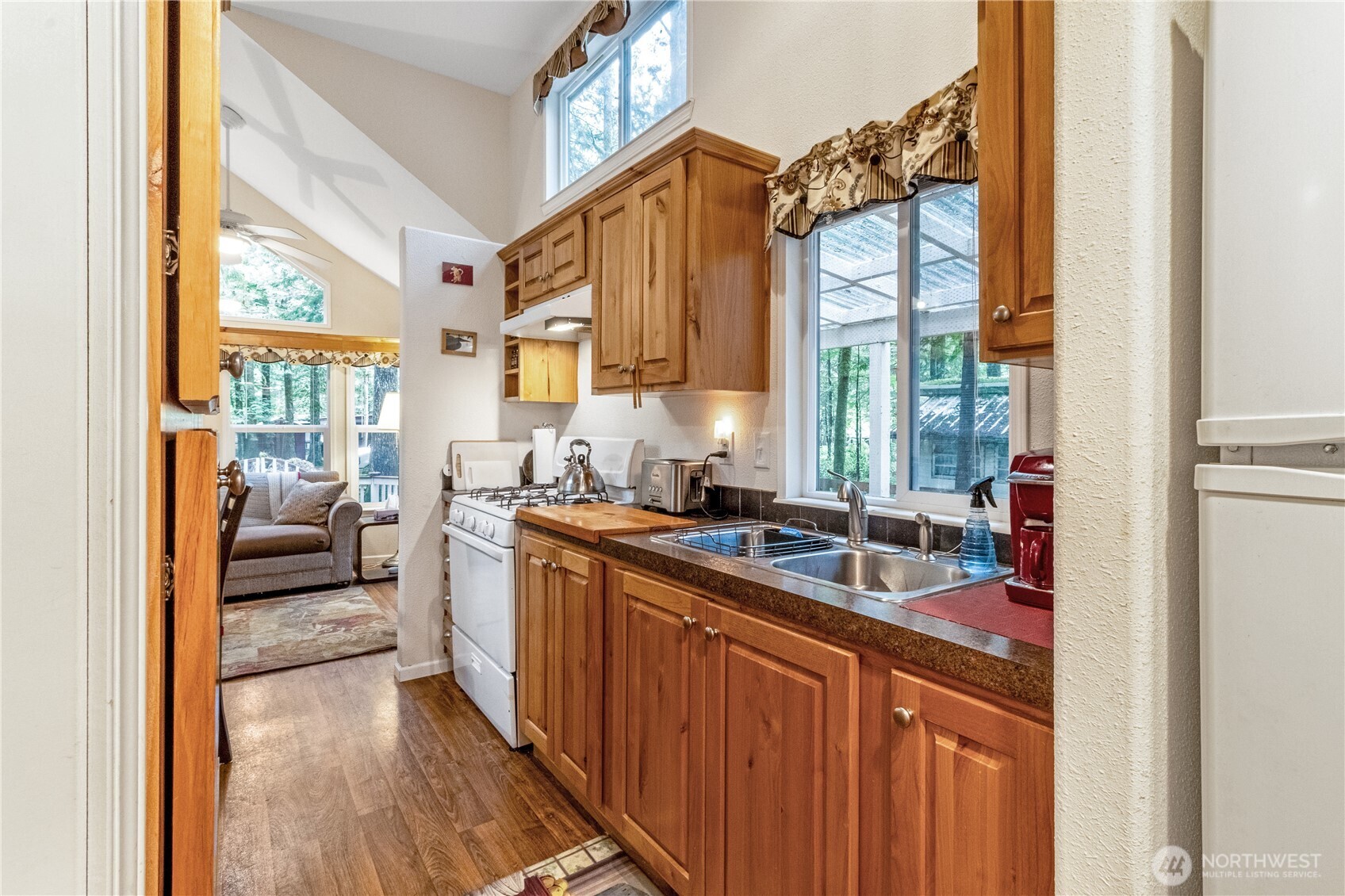 86-3 Sunset Circle Maple Falls, WA 98266 - Photo 12 of 38 a kitchen with granite countertop a sink and a refrigerator