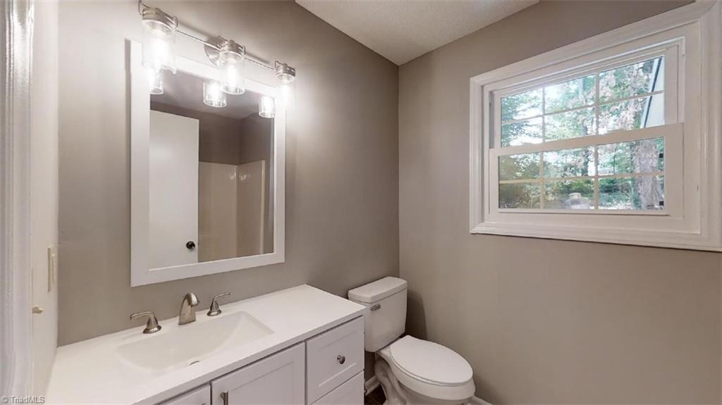 317 Staplewood Road Lexington, NC 27295 - Photo 16 of 34 Main Bath First Floor with new vanity, light, mirror and flooring