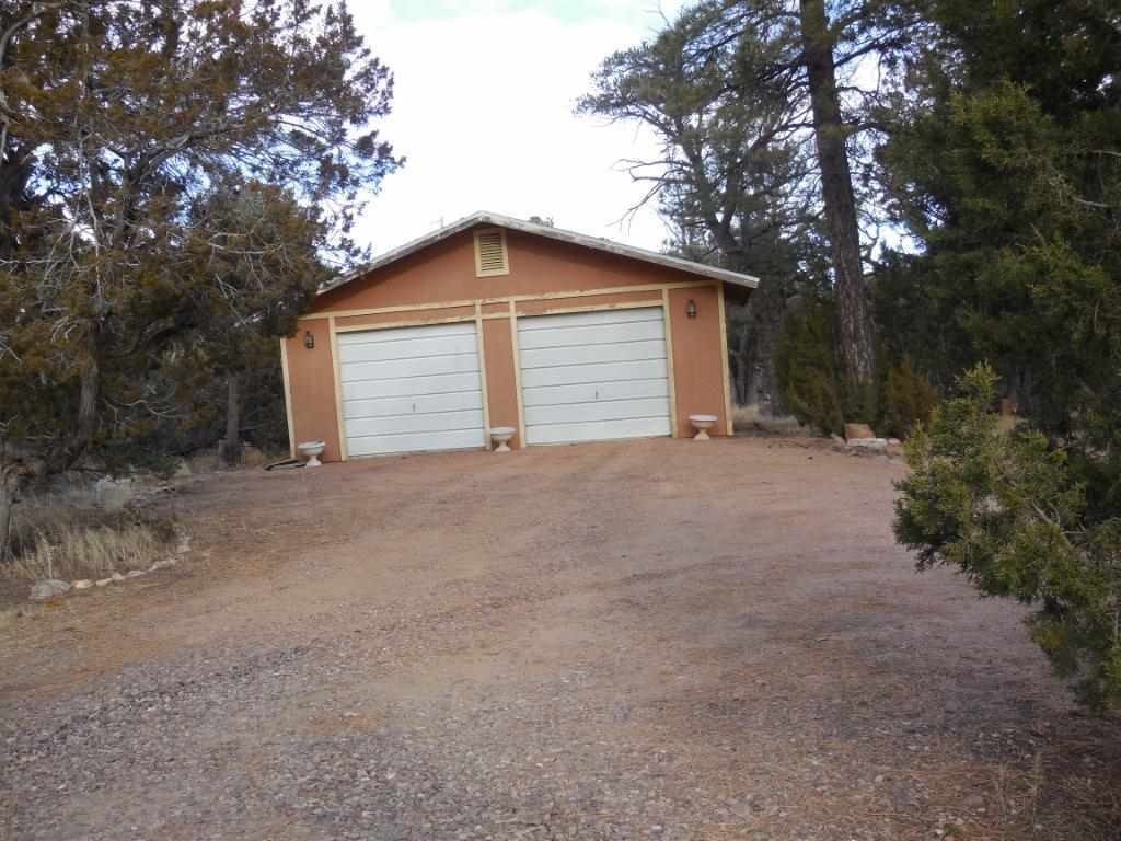 3060 A Chevelon Road Overgaard, AZ 85933 - Photo 8 of 14 a view of large house with large tree and wooden fence