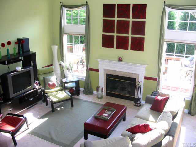 9016 Breeland Way Raleigh, NC 27613 - Photo 3 of 10 Great living room with two-story vaulted ceiling, tall double windows, & gas log fireplace Other