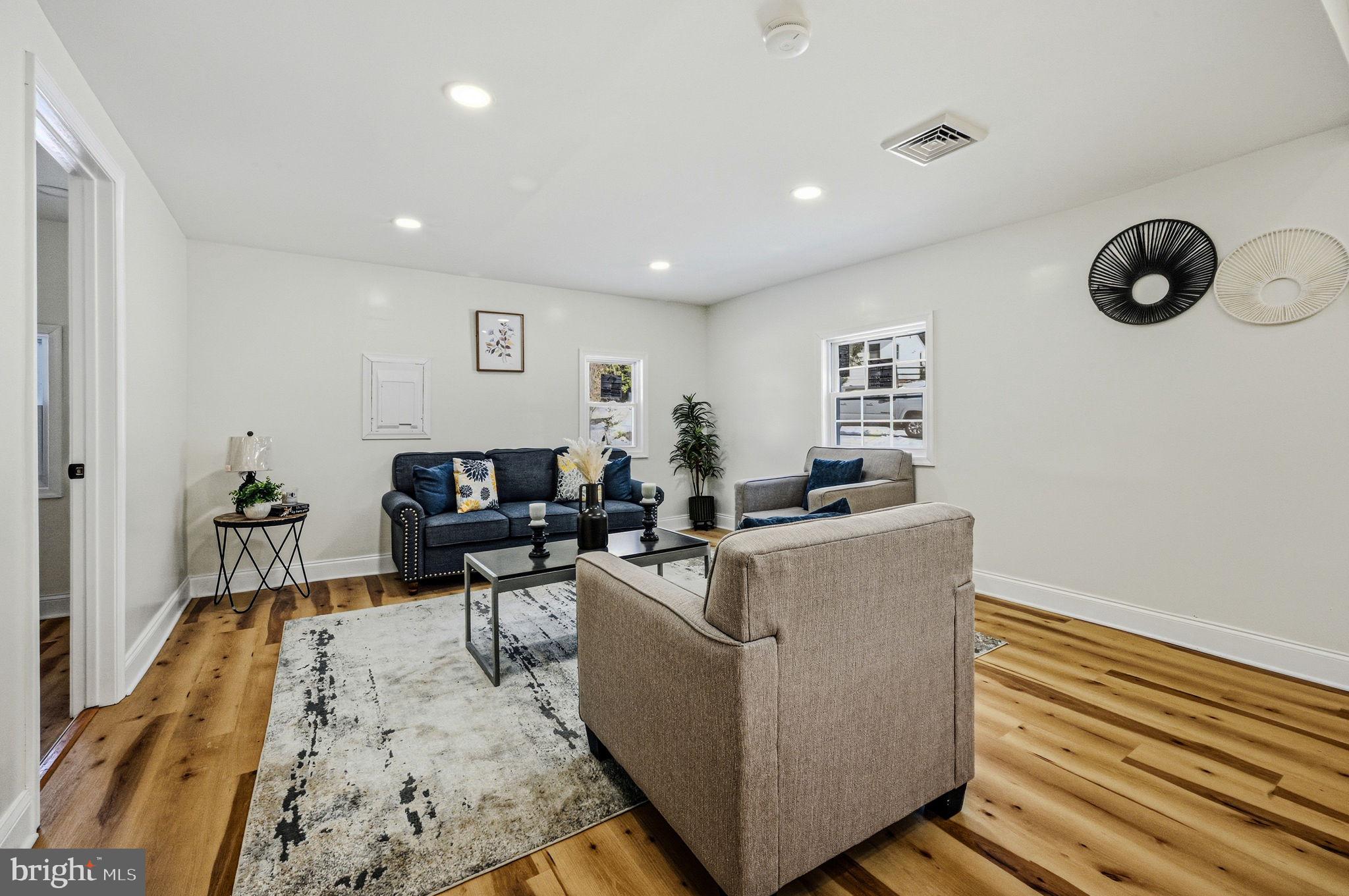 4 Lower Greenbriar Road Wilmington, DE 19810 - Photo 15 of 42 a living room with furniture and a wooden floor