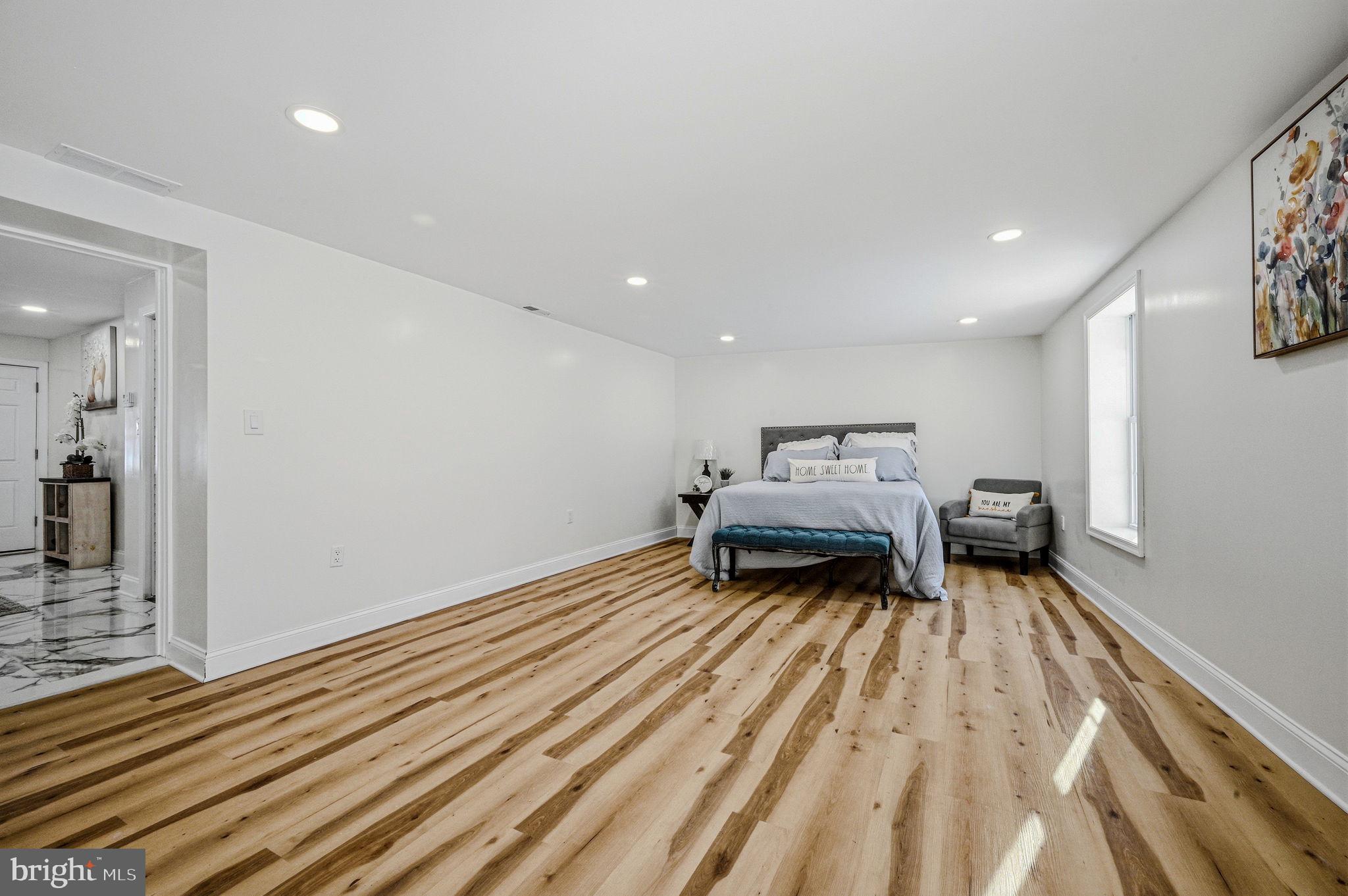 4 Lower Greenbriar Road Wilmington, DE 19810 - Photo 29 of 42 a bedroom with a bed and wooden floor