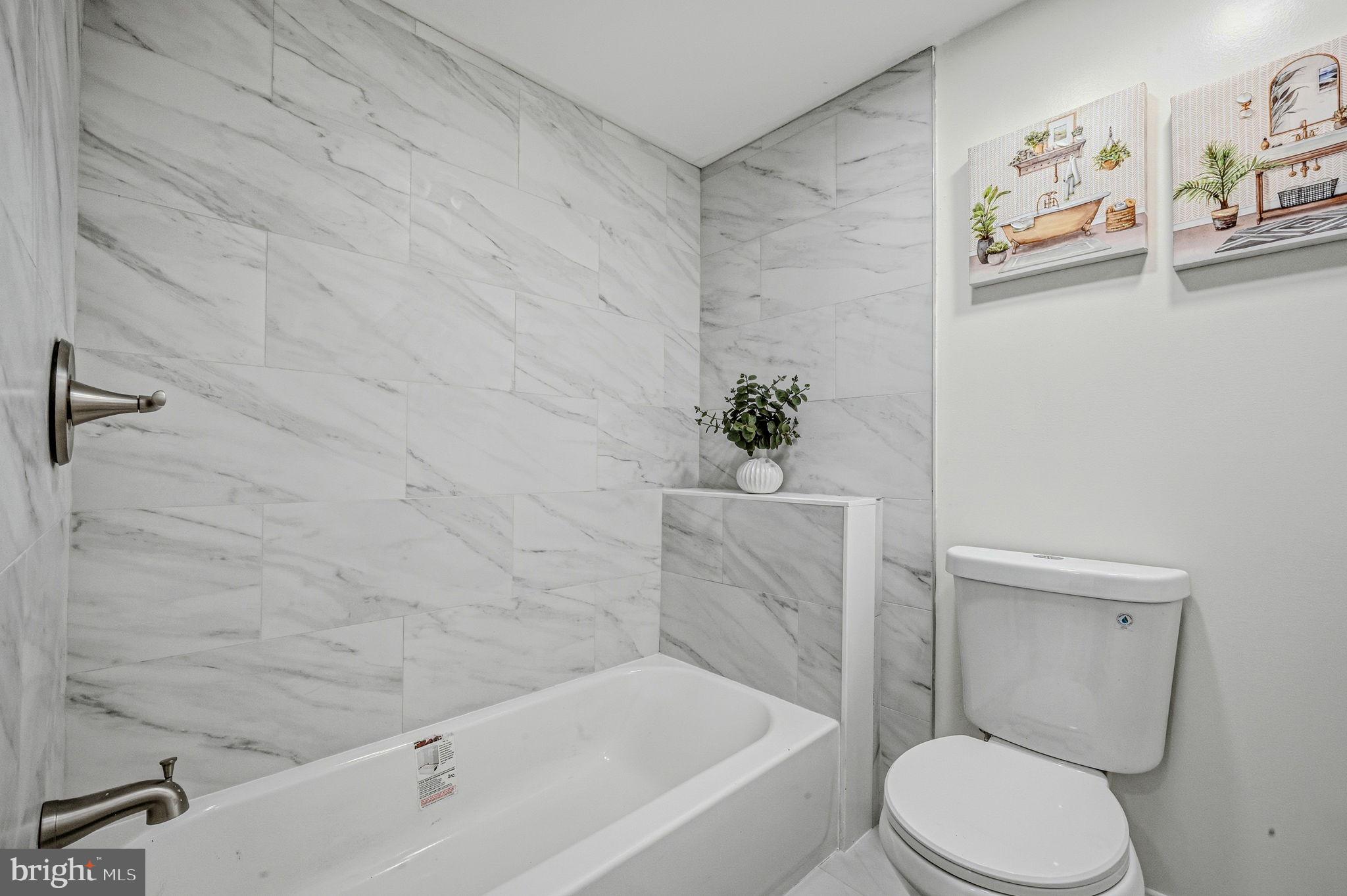 4 Lower Greenbriar Road Wilmington, DE 19810 - Photo 31 of 42 a white toilet sitting next to a bath tub